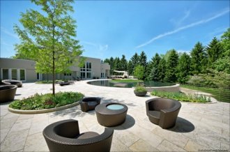 The rich outside living area includes a patio cooking area.