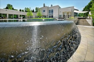 The share pavilion area off of the primary residence includes an Infinity Pool.